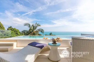 Luxurious beachfront pool with stunning ocean view and modern lounge chairs