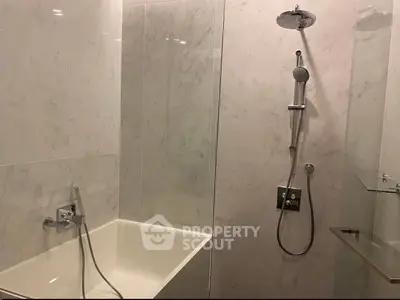 Luxurious marble bathroom with modern shower and bathtub