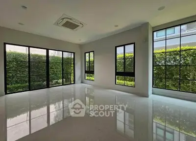 Spacious modern living room with large windows and garden view