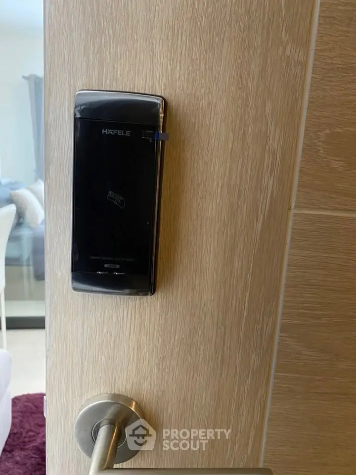 Modern smart lock on wooden door in contemporary apartment interior.