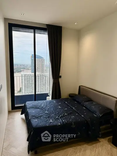 Modern bedroom with city view and large window in high-rise apartment