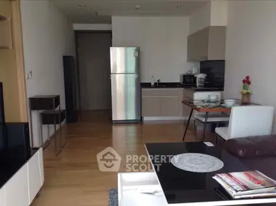 Modern open-layout kitchen with sleek appliances and dining area in a stylish apartment.