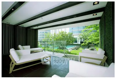 Luxurious modern balcony with stunning garden view and stylish seating area.