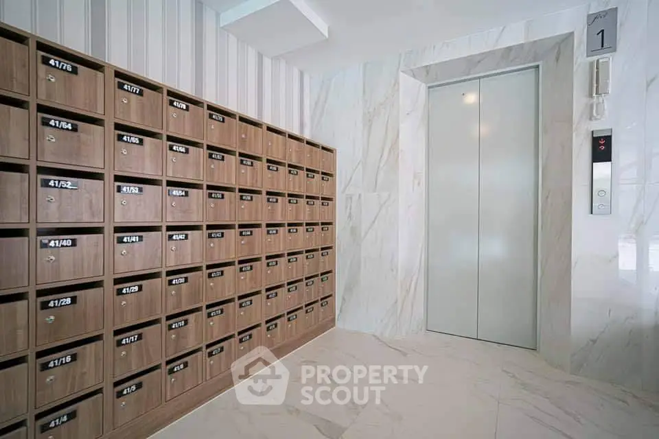 Modern apartment building lobby with mailboxes and elevator access
