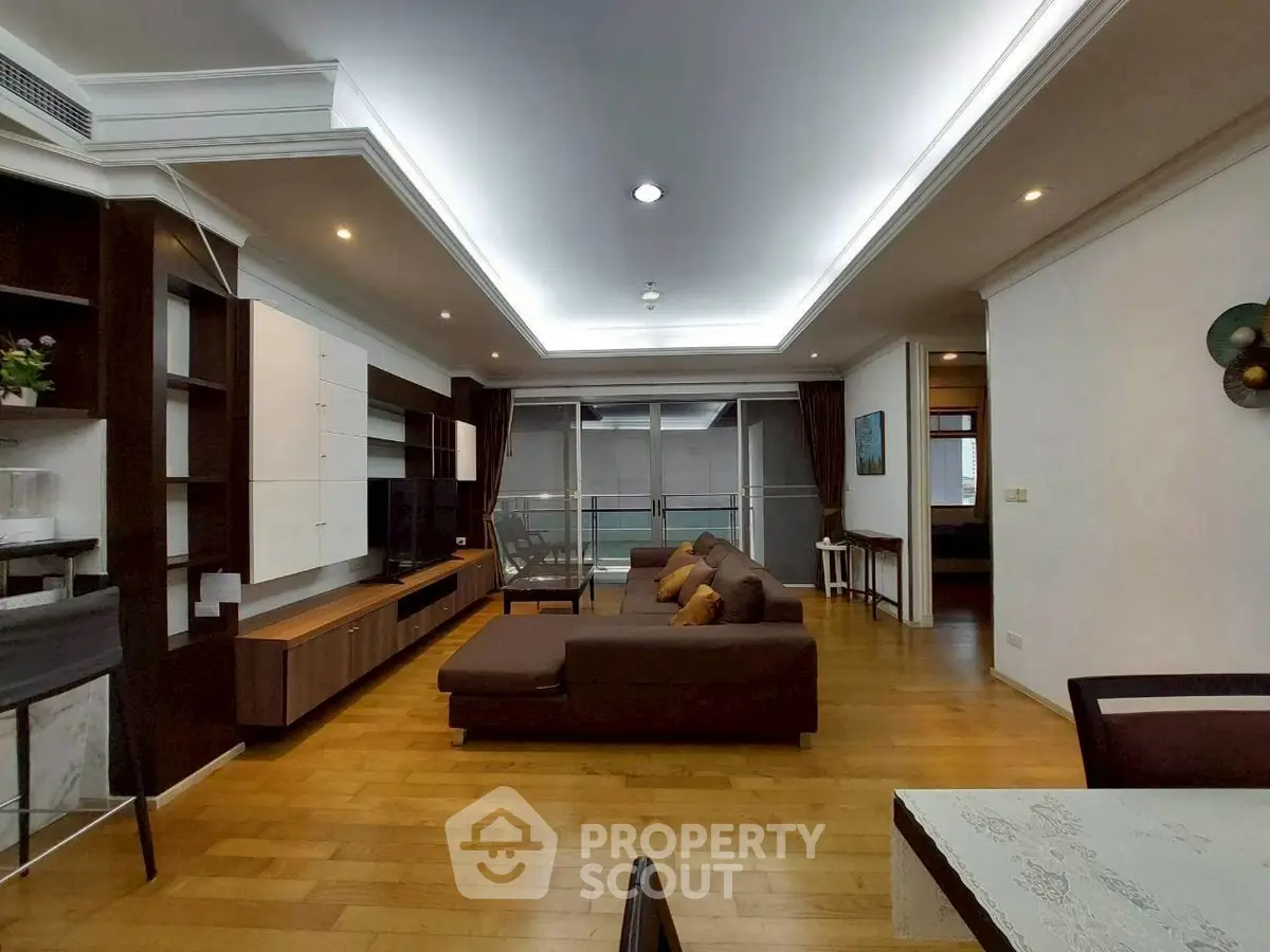 Spacious modern living room with elegant wooden flooring and stylish furniture.