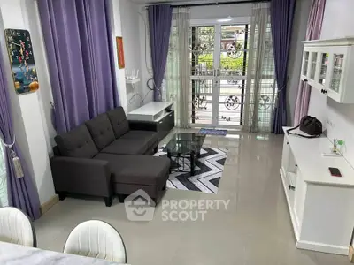 Modern living room with stylish decor and large windows offering natural light.