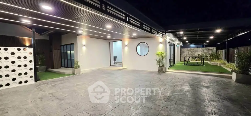 Modern covered outdoor area with stylish lighting and seating, perfect for entertaining.