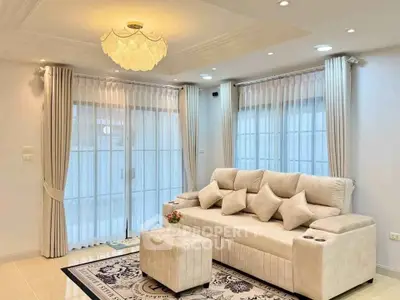 Elegant living room with plush sofa, stylish lighting, and large windows for natural light.