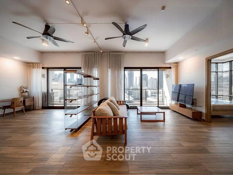 Spacious modern living room with city view and stylish wooden flooring