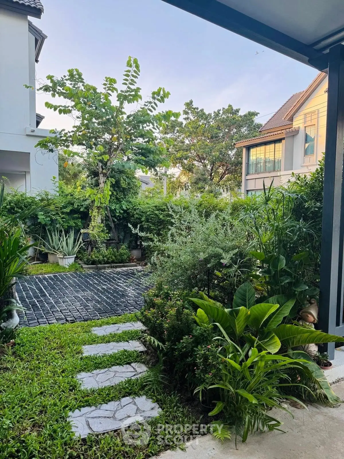 Charming garden view with lush greenery and modern architecture in a serene residential area.