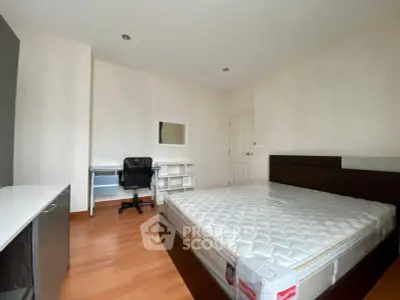 Spacious bedroom with modern furniture and ample natural light