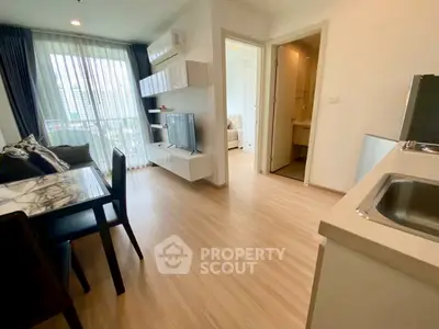 Modern living room with open layout and natural light in a stylish apartment.
