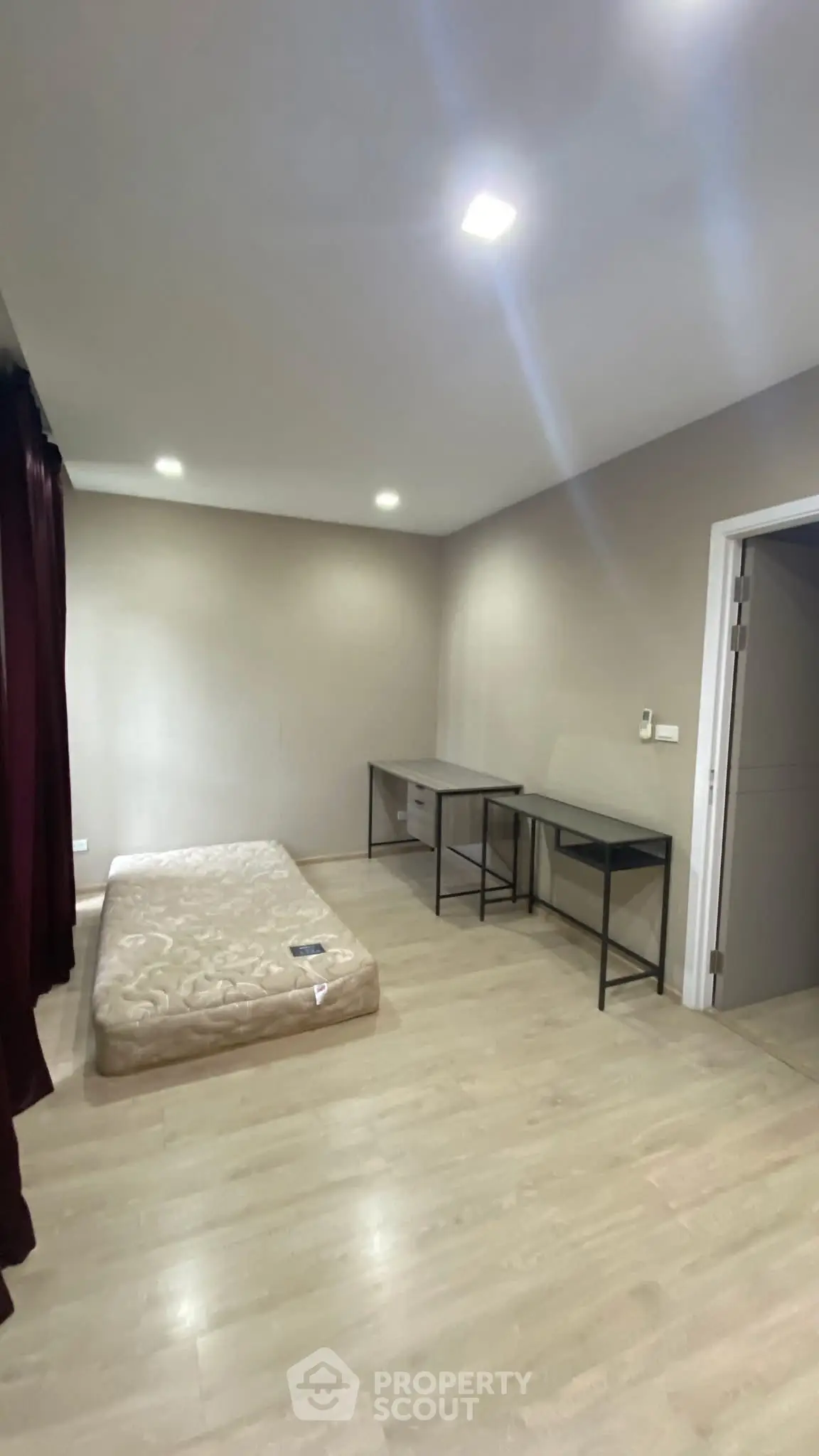 Spacious bedroom with minimalist design and natural light