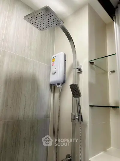 Modern bathroom shower with sleek fixtures and glass shelves, perfect for a contemporary home.