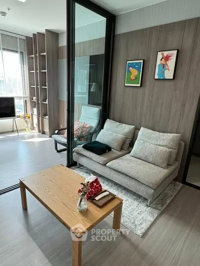 Modern living room with stylish decor and large windows offering natural light.
