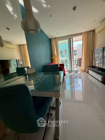 Modern living room with stylish decor and balcony access, featuring sleek furniture and ample natural light.