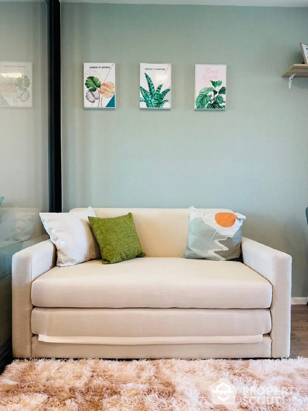 Cozy living room with stylish beige sofa and decorative cushions, perfect for relaxation.