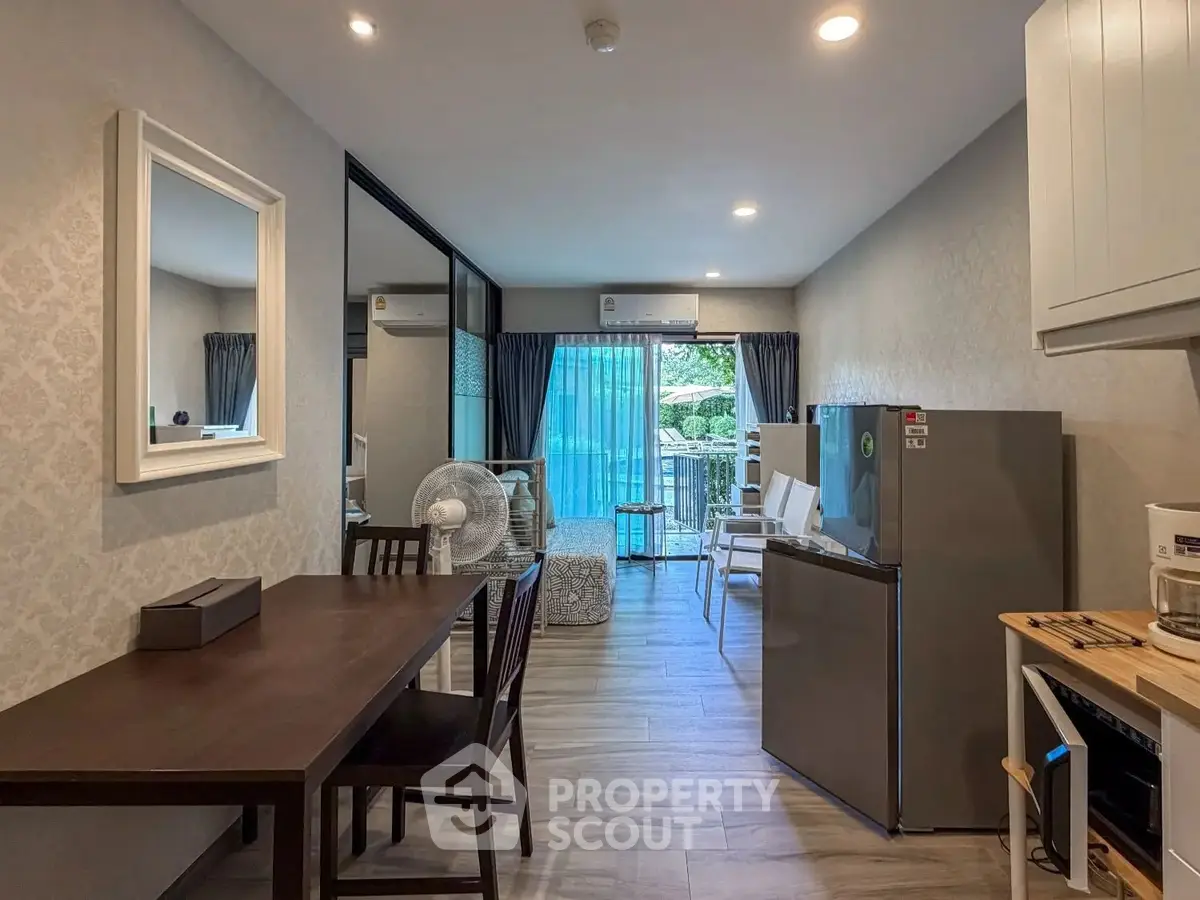 Modern open-plan living room with dining area and balcony view