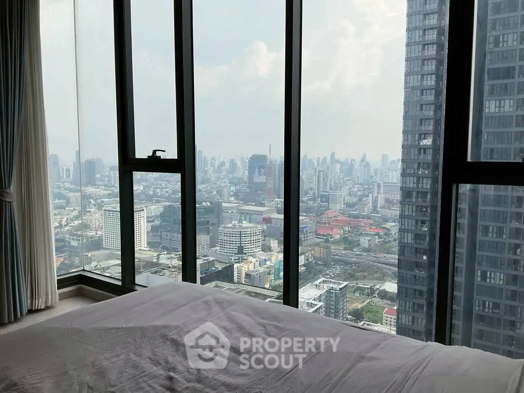 Stunning cityscape view from a modern high-rise bedroom window, offering a serene urban living experience.