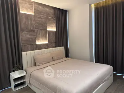 Modern bedroom with stylish lighting and elegant curtains, perfect for a cozy retreat.