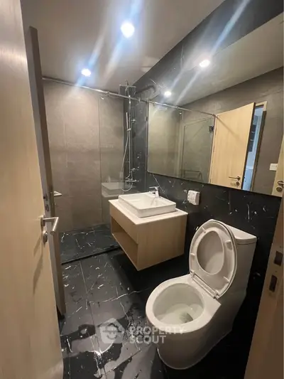 Modern bathroom with sleek fixtures and elegant black marble flooring