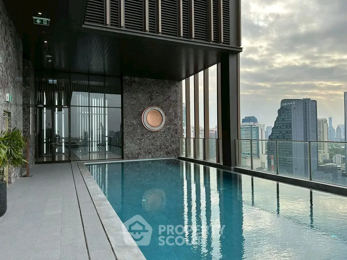 Luxurious rooftop pool with stunning city skyline views in modern high-rise building.