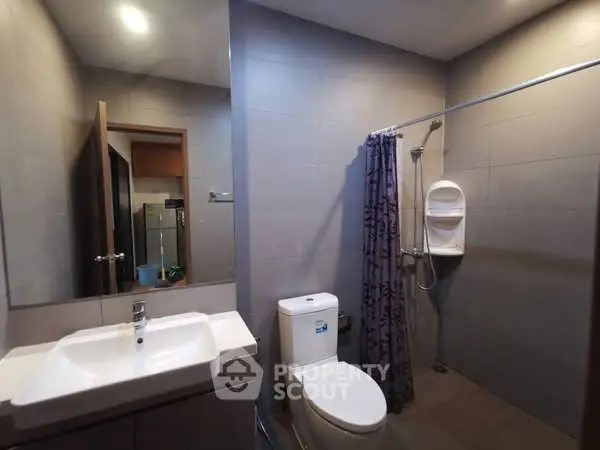 Modern bathroom with sleek fixtures and spacious shower area