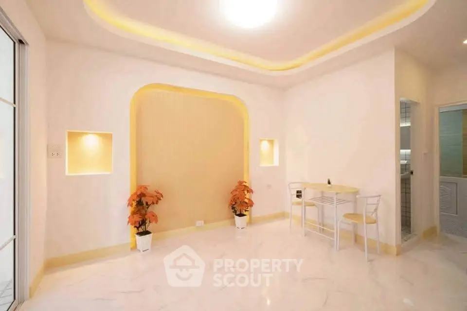 Bright modern living room with elegant recessed lighting and marble flooring