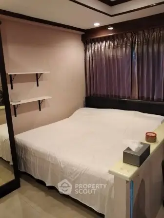 Cozy bedroom with large bed and elegant curtains, perfect for restful nights.