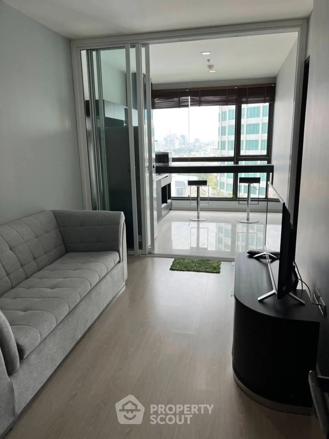 Modern living room with sleek furniture and city view, perfect for urban living.