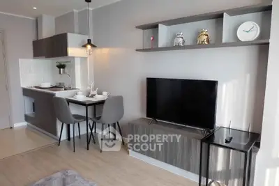 Modern living room with stylish decor and compact kitchen area, perfect for urban living.