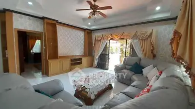 Spacious living room with elegant decor and large windows for natural light.