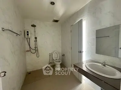 Spacious modern bathroom with sleek fixtures and elegant marble walls