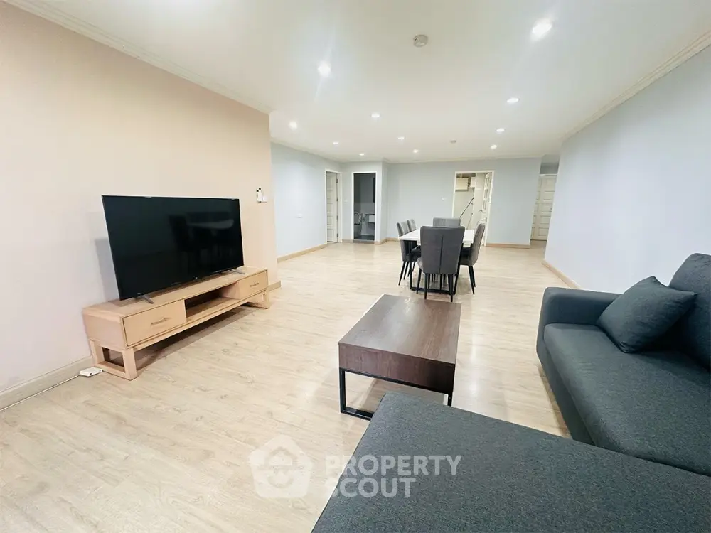 Spacious modern living room with sleek furniture and open dining area