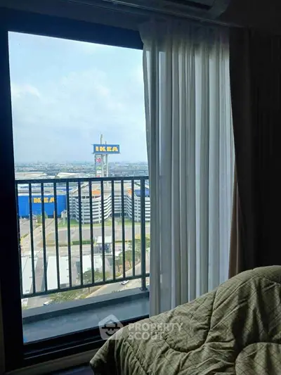Stunning high-rise bedroom view overlooking IKEA and cityscape, perfect for urban living.