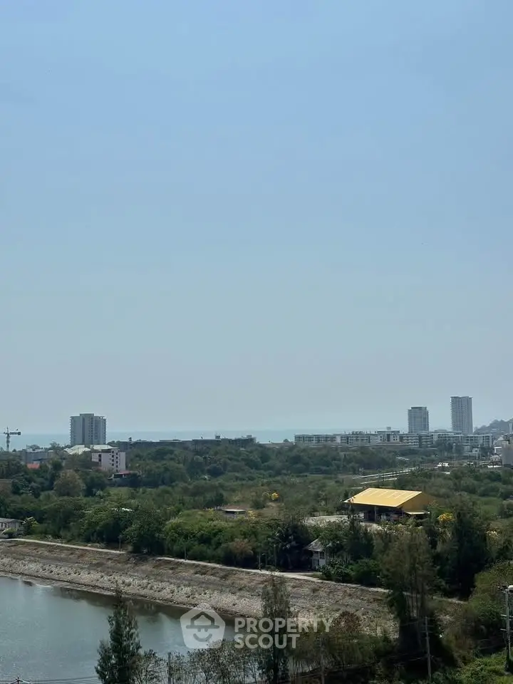 Stunning panoramic view of cityscape with distant ocean horizon, ideal for serene living.