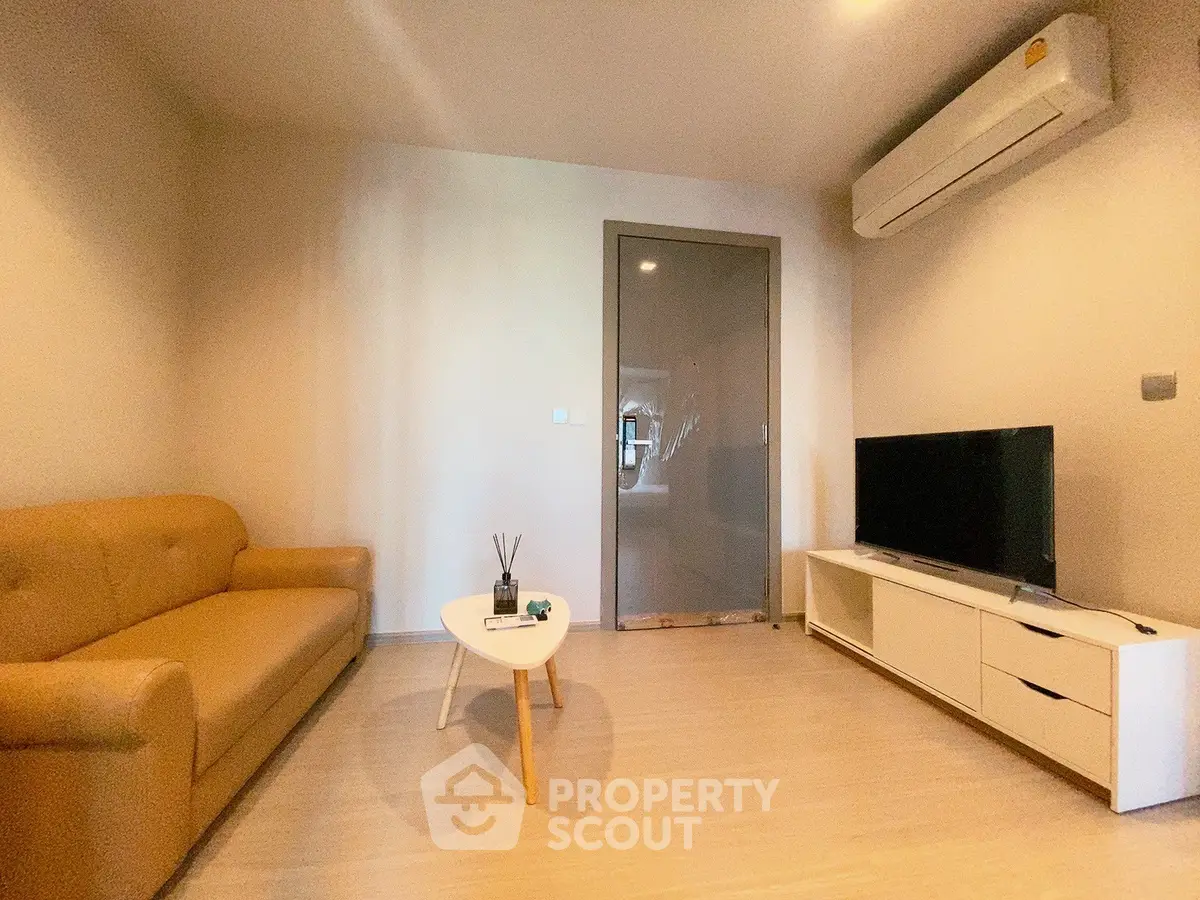 Modern living room with sleek furniture and air conditioning, perfect for comfortable living.
