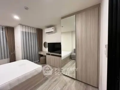 Modern bedroom with stylish furniture and mirrored wardrobe