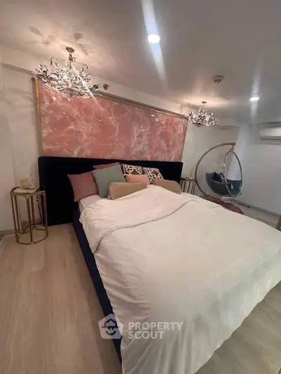 Luxurious bedroom with elegant decor and modern lighting, featuring a plush bed and stylish furnishings.