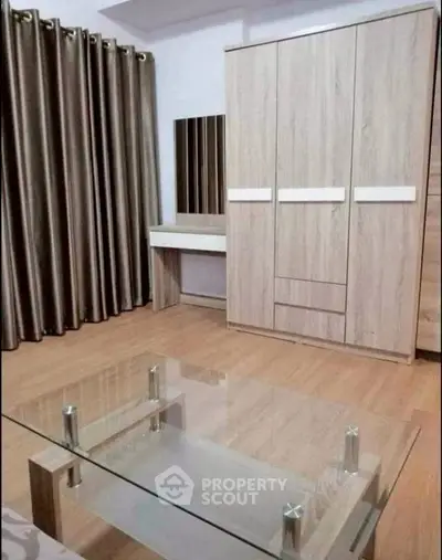 Modern bedroom with wooden wardrobe and glass coffee table