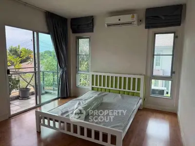 Spacious bedroom with balcony access and natural light in modern home.