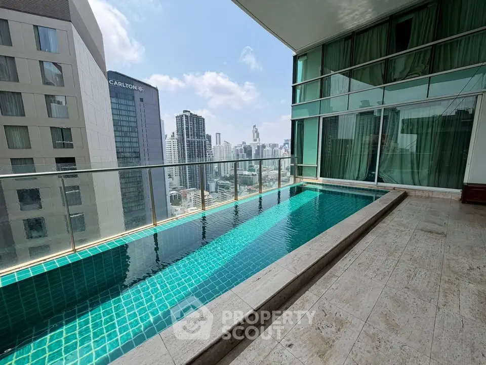 Luxurious rooftop pool with stunning city skyline views in a modern high-rise building.
