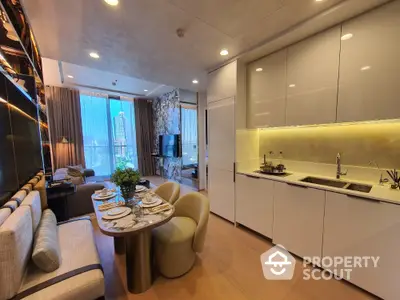 Luxurious open-plan living room and kitchen with modern decor and city view.