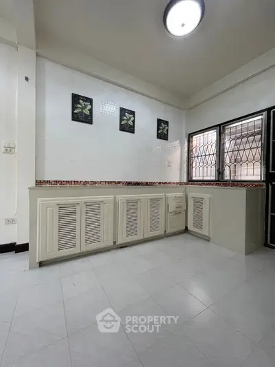 Spacious kitchen with closed layout and modern cabinetry