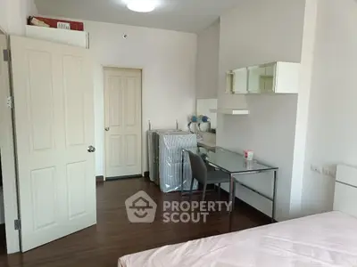 Modern bedroom with wooden flooring and sleek furniture in a cozy apartment