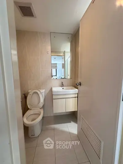Modern bathroom with sleek fixtures and neutral tones, perfect for a contemporary home.