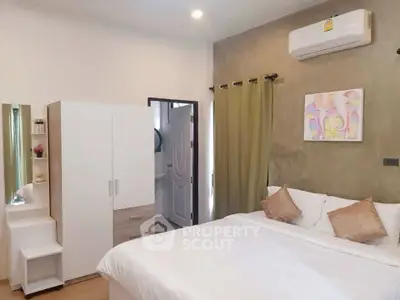 Cozy bedroom with modern decor and air conditioning, featuring a comfortable bed and stylish wardrobe.