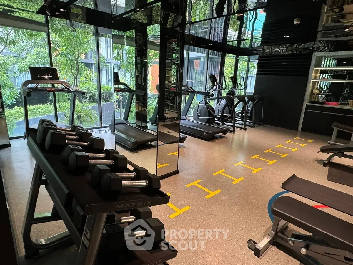 Modern gym with state-of-the-art equipment and lush garden view.