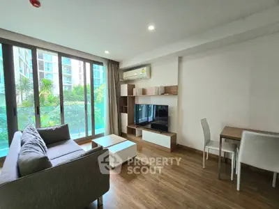 Modern living room with sleek furniture and large windows in a stylish apartment.