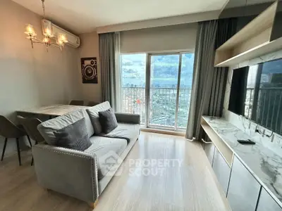 Modern living room with elegant decor and stunning city view from large windows.